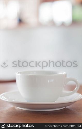 White mug on wooden table, stock photo