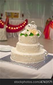 White multi level wedding cake with flower decorations