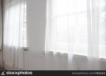 White net curtain against two windows in a house, interior. White net curtain against two windows in a house,