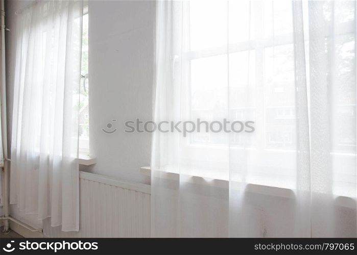 White net curtain against two windows in a house, interior. White net curtain against two windows in a house,
