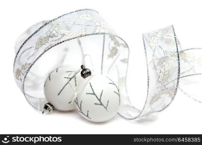 White New Year&rsquo;s balls and decorative tape on a white background