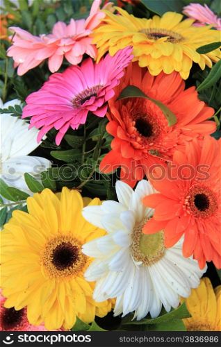White, orange, pink, yellow and red gerberas in a colorful wedding bouquet