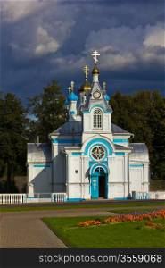 white orthodox church with gleaming crosses on a dark stormy sky