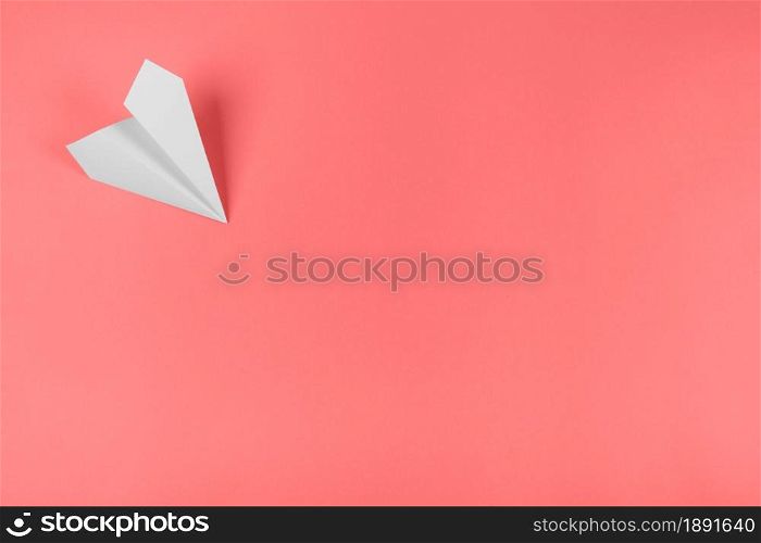 white paper airplane corner coral background. Resolution and high quality beautiful photo. white paper airplane corner coral background. High quality and resolution beautiful photo concept