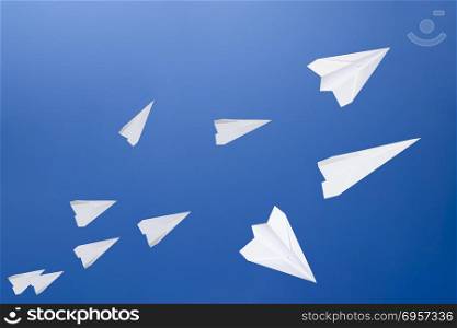 White paper airplanes against the blue sky. The symbol of freedom and privacy on the Internet. White paper airplanes against the blue sky. The symbol of freedom and privacy on the Internet.. White paper airplanes against the blue sky. The symbol of freedom and privacy on the Internet.