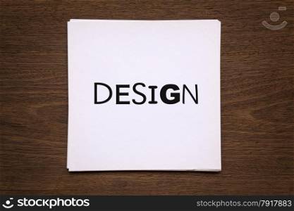 "White paper cards with word " Design " putting on natural wood background, vignette and top view image"
