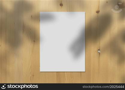 White paper Mockup displayed on wooden wall with realistic shadows overlays leaves on beige background, banner for Promotion marketing, background for aesthetic creative design