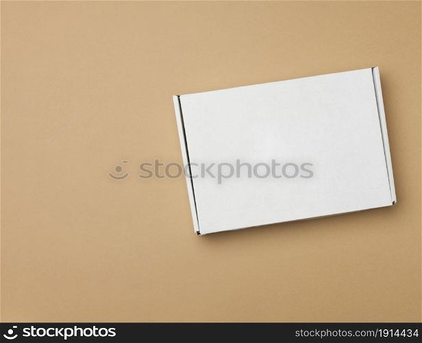 white paper rectangular box on beige background, top view