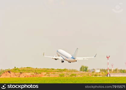 white passenger aircraft takes off from the strip