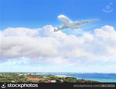 White passenger plane flying in the day blue sky above a city