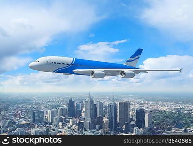 White passenger plane flying in the day blue sky above a city