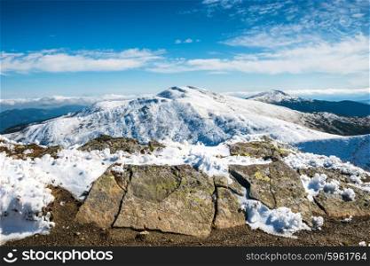 White peaks of mountains with rocks in snow. Winter landscape