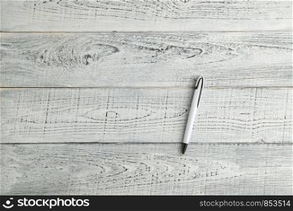 white pen on vintage shabby white wooden background. the view from the top. flat lay
