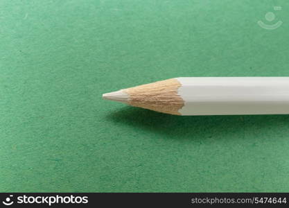 white pencil on green background