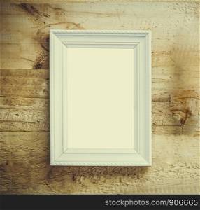 White picture frame put on old brown wooden table use for texts or picture display