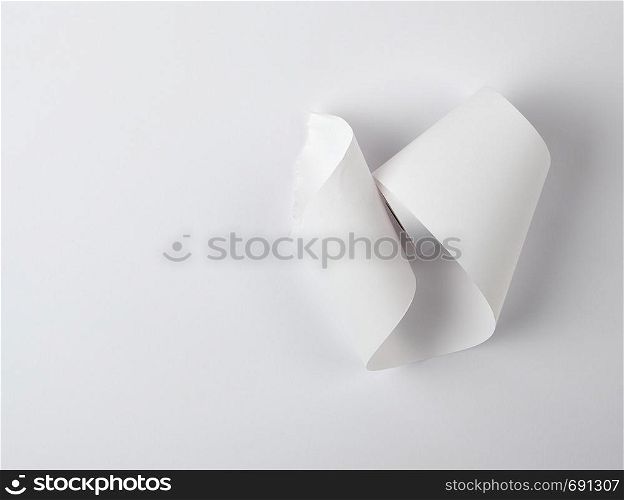 white piece of paper is twisted, white background, copy space
