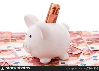 White piggy bank with euro bills over a white background