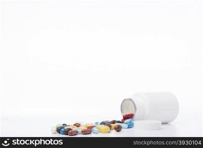 White pill bottle.Pills on a white background. White pill bottle.Pills on a white background.