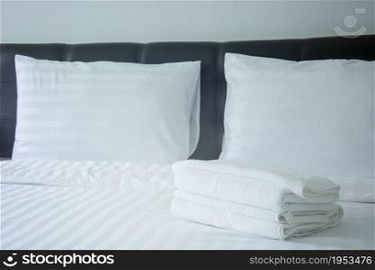 white pillow and blanket with wrinkle messy on bed in bedroom with lighting upper left side, from sleeping in a long night winter.