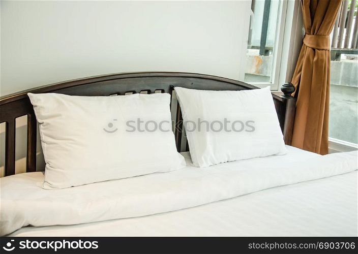 White pillow in the bedroom luxury hotel.