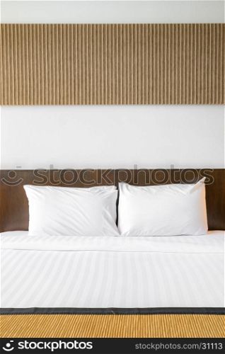 White pillow on bed with table light lamp decoration in bedroom interior