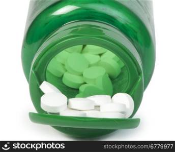 White pills and a container of pills. White siolated studio shot