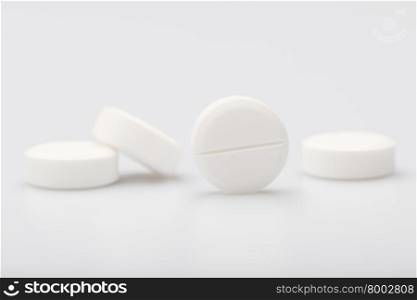 White pills on a white background. White round pills on a white background