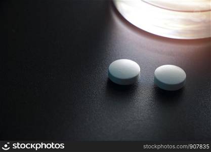 white pills on black background, insomnia