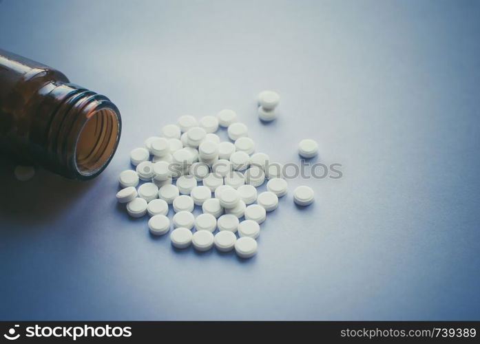 White pills with a glass brown bottle. Heart shape. tablets. Addiction. White pills with a glass brown bottle. Heart shape. tablets