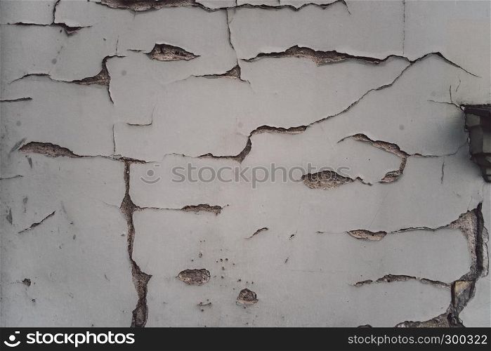White plaster wall with cracks