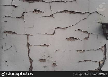 White plaster wall with cracks