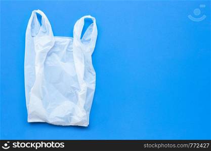 White plastic bag on blue background. Copy space