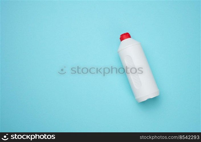 White plastic bottle for liquid on a blue background, top view. Copy space