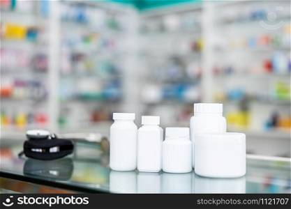 white plastic bottle medicine package on counter in pharmacy store Thailand