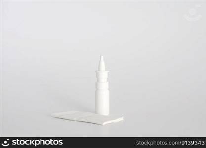 White plastic nasal spray bottle on white background. Nasal spray container, saline water solution for nose congestion treatment. Runny nose, colds. Free space, copy space. White plastic nasal spray bottle on white background. Nasal spray container, saline water solution for nose congestion treatment. Runny nose, colds. Free space, copy space.