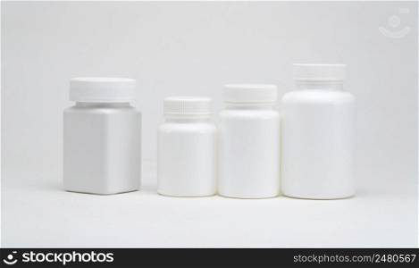 White plastic pill jars on a white background. Isolated. plastic pill jars
