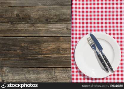 white plate checkered table cloth wooden textured plank. High resolution photo. white plate checkered table cloth wooden textured plank. High quality photo
