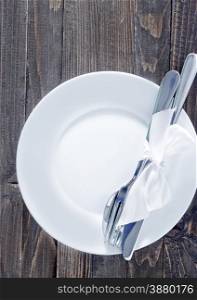 white plate, fork and knife on plate