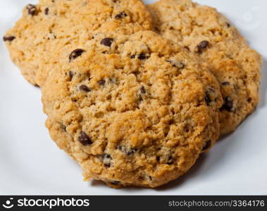 White plate of home made chocolate chip cookies just out of the oven