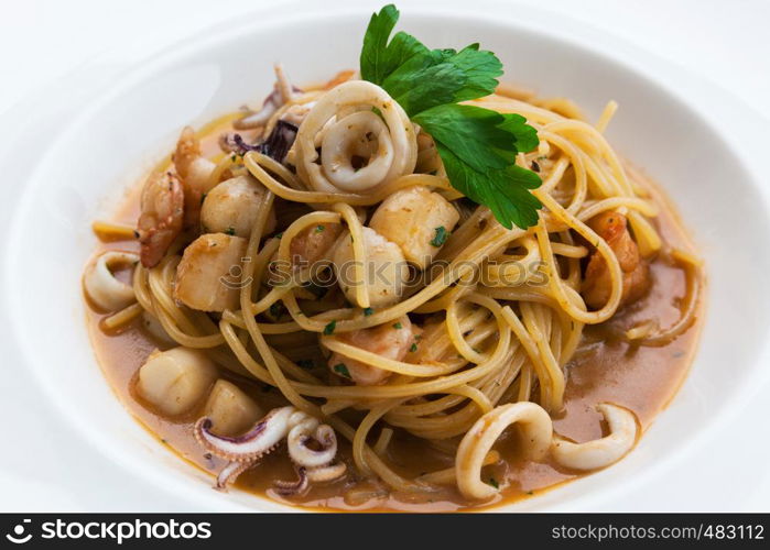 white plate with pasta and seafood