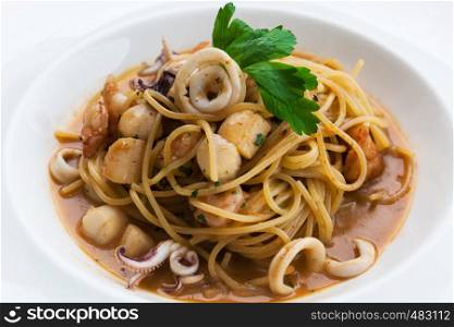 white plate with pasta and seafood