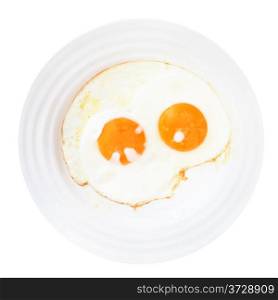 white plate with two fried eggs isolated on white background