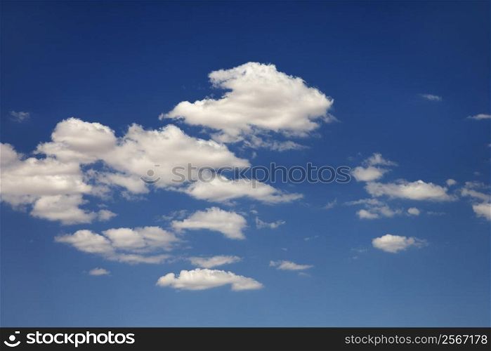 White puffy clouds in blue sky.