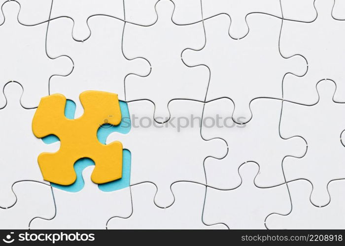 white puzzle grid with yellow puzzle piece backdrop