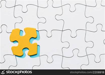 white puzzle grid with yellow puzzle piece backdrop