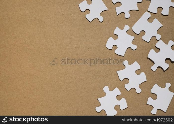 white puzzle pieces brown paper backdrop. High resolution photo. white puzzle pieces brown paper backdrop. High quality photo