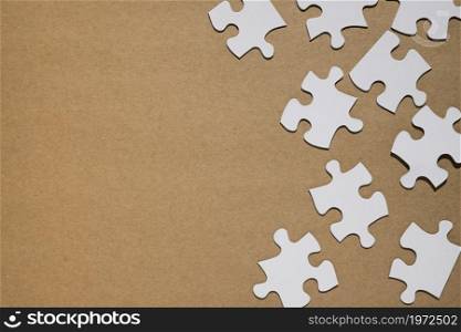 white puzzle pieces brown paper backdrop. High resolution photo. white puzzle pieces brown paper backdrop. High quality photo
