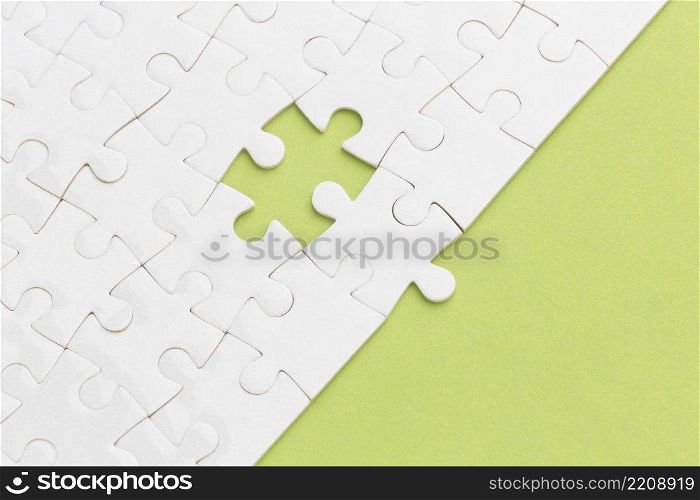 white puzzle with one piece missing
