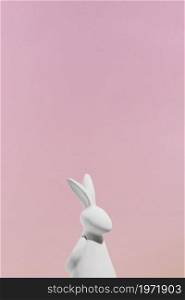 white rabbit figurine pink background. High resolution photo. white rabbit figurine pink background. High quality photo