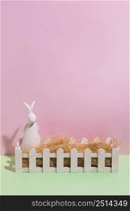 white rabbit figurine with hay box table